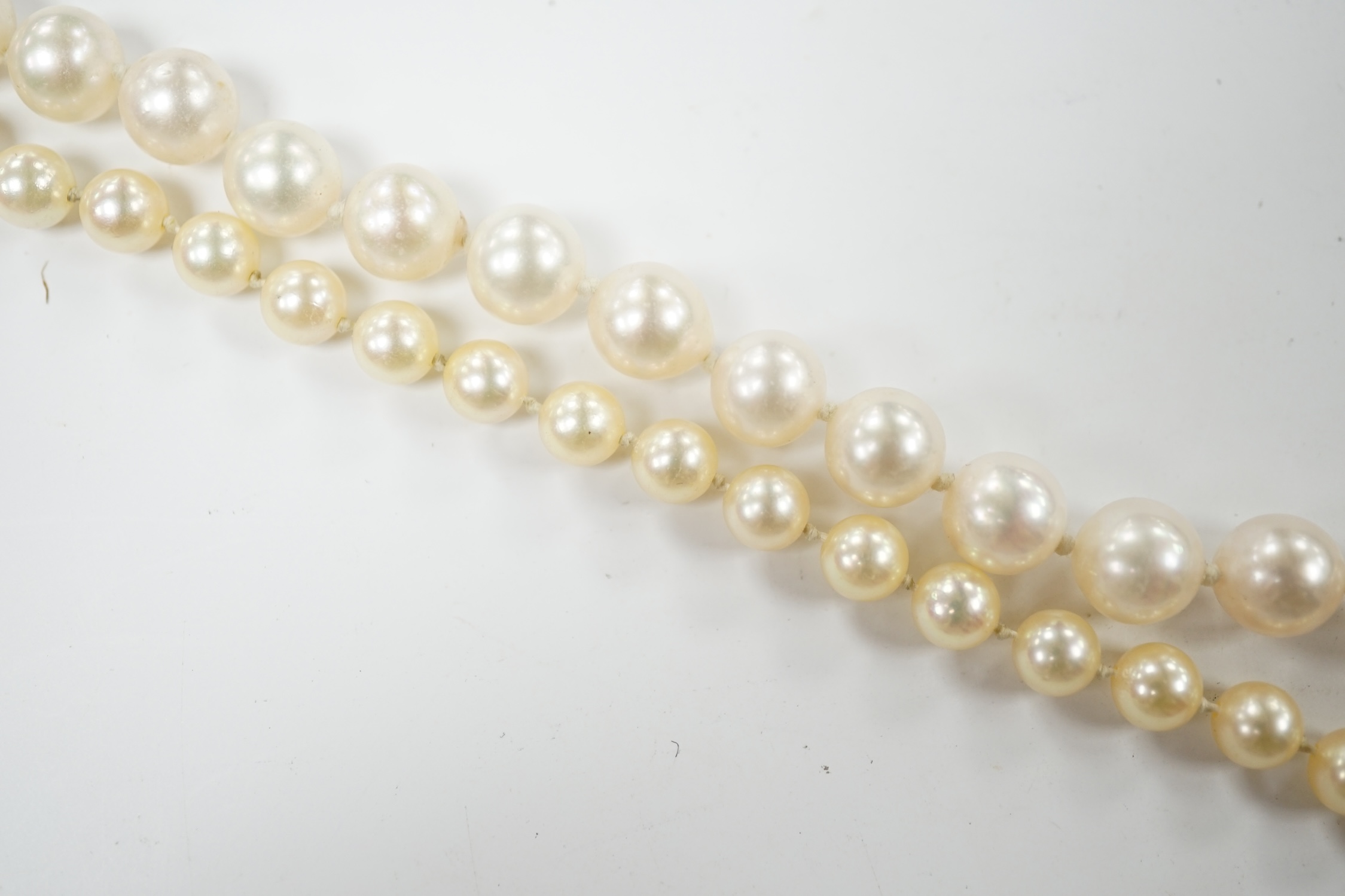 A single strand cultured pearl necklace, with 18k and multi gem set spherical clasp, 48cm, and one other single strand cultured pearl necklace, with 9ct gold and cultured pearl set clasp. Condition - fair
